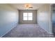 Neutral bedroom with carpet, a ceiling fan, and a large window for natural light at 1000 Sweetgum St, Gastonia, NC 28054