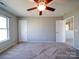 Bright bedroom with carpet, neutral walls, ceiling fan and ample space at 1000 Sweetgum St, Gastonia, NC 28054