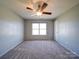 Neutral bedroom with carpet, a ceiling fan, and a large window for natural light at 1000 Sweetgum St, Gastonia, NC 28054