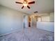 Bright bonus room featuring a ceiling fan and a view of the hallway and bathroom at 1000 Sweetgum St, Gastonia, NC 28054
