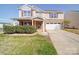 Charming two-story home featuring a stone facade, attached two-car garage, and a well-manicured lawn at 1000 Sweetgum St, Gastonia, NC 28054