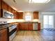 Updated kitchen with stainless appliances, ample cabinetry, and a view to the open living and outdoor spaces at 1000 Sweetgum St, Gastonia, NC 28054