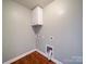 Efficient laundry area with a white storage cabinet and hookups ready for appliances at 1000 Sweetgum St, Gastonia, NC 28054