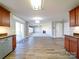 Spacious open-concept living area with wood floors, modern lighting, and seamless transition to the kitchen space at 1000 Sweetgum St, Gastonia, NC 28054