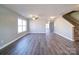 Open-concept living area boasting laminate floors, a ceiling fan, and an abundance of natural light at 1000 Sweetgum St, Gastonia, NC 28054