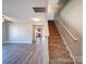 Bright, open-concept living room with modern flooring and staircase access to the upper level at 1000 Sweetgum St, Gastonia, NC 28054