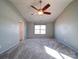 Bright and airy main bedroom featuring a ceiling fan and a large window for ample sunlight at 1000 Sweetgum St, Gastonia, NC 28054