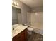 Bathroom with a wood vanity, a white sink, and a tub-shower combo, offering functionality and style at 104 Johnsbury Dr, Stanley, NC 28164