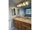 Well-lit bathroom with granite countertops and a mirrored backsplash and lighting at 104 Johnsbury Dr, Stanley, NC 28164