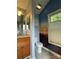 Well-lit bathroom featuring a vanity with granite countertop and artistic wall decor at 104 Johnsbury Dr, Stanley, NC 28164