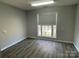 Bedroom featuring wood floors, a large window, and neutral walls creating a bright and airy space at 104 Johnsbury Dr, Stanley, NC 28164