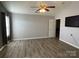Large bedroom with a ceiling fan, light gray walls and sleek hard surface floors at 104 Johnsbury Dr, Stanley, NC 28164