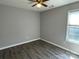 This bedroom features stylish wood floors, a modern ceiling fan, and a bright window for natural light at 104 Johnsbury Dr, Stanley, NC 28164