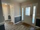 Bright foyer with wood-look flooring, decorative front door, and neutral two-tone paint scheme at 104 Johnsbury Dr, Stanley, NC 28164