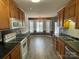 Eat-in kitchen featuring wood cabinets, smooth cooktop, and stainless-steel appliances at 104 Johnsbury Dr, Stanley, NC 28164