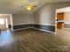 Open-concept living room with ceiling fan, vaulted ceilings, and seamless flow into the kitchen at 104 Johnsbury Dr, Stanley, NC 28164