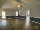 Large living room featuring wood-look floors, neutral paint, and access to back deck at 104 Johnsbury Dr, Stanley, NC 28164