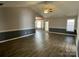 Spacious living room features vaulted ceiling, ceiling fan, and wood-look floors at 104 Johnsbury Dr, Stanley, NC 28164