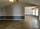 Bright living room featuring wood-look floors, neutral paint, and lots of natural light at 104 Johnsbury Dr, Stanley, NC 28164