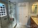 Step-in shower featuring new tile, built-in soap and shampoo holders and a unique glass block window at 104 Johnsbury Dr, Stanley, NC 28164