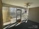 Enclosed sunroom featuring a ceiling fan, and door leading to outdoor deck area at 104 Johnsbury Dr, Stanley, NC 28164