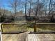 An elevated wooden deck with railings, offering a view of the backyard and surrounding greenery at 104 Johnsbury Dr, Stanley, NC 28164