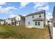 Backyard view showing a well-maintained lawn, concrete patio, and privacy fence at 1120 Freeman View Dr, Albemarle, NC 28001