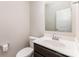 A clean half-bath with a wood-stained cabinet and a good-sized mirror at 1120 Freeman View Dr, Albemarle, NC 28001