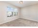 A carpeted bedroom with two large windows at 1120 Freeman View Dr, Albemarle, NC 28001