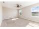 A carpeted bedroom, featuring two windows and a ceiling fan at 1120 Freeman View Dr, Albemarle, NC 28001