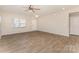 Bright living room features wood-look floors, ceiling fan, and plenty of natural light at 1120 Freeman View Dr, Albemarle, NC 28001