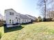 Wide backyard view showcasing patio, fire pit, and fenced perimeter at 12729 Mcginnis Ln, Huntersville, NC 28078