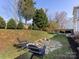 Well-maintained backyard with a stone fire pit, chairs, and grassy lawn at 12729 Mcginnis Ln, Huntersville, NC 28078