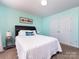 Bedroom with turquoise walls, carpet flooring, and a double door closet at 12729 Mcginnis Ln, Huntersville, NC 28078