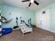 bedroom featuring a ceiling fan, themed decorations, and carpeted floor at 12729 Mcginnis Ln, Huntersville, NC 28078