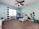 Dinosaur themed bedroom with ceiling fan and a playful, imaginative decor at 12729 Mcginnis Ln, Huntersville, NC 28078
