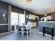 Breakfast nook with a view of the kitchen and modern pendant lighting at 12729 Mcginnis Ln, Huntersville, NC 28078