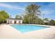 Community pool and amenity center surrounded by lush landscaping and offering residents a refreshing retreat at 12729 Mcginnis Ln, Huntersville, NC 28078