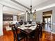 Inviting dining area with hardwood floors and elegant chandelier, adjacent to the living room at 12729 Mcginnis Ln, Huntersville, NC 28078
