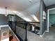 Upstairs hallway with carpet flooring, gray walls, and dark staircase railing at 12729 Mcginnis Ln, Huntersville, NC 28078