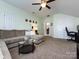 Spacious upstairs living room with large couch and ceiling fan at 12729 Mcginnis Ln, Huntersville, NC 28078