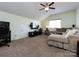Cozy living room with vaulted ceiling, ceiling fan, and large sectional couch at 12729 Mcginnis Ln, Huntersville, NC 28078