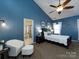 Well-lit main bedroom with a cozy chair, ceiling fan, and access to the bathroom at 12729 Mcginnis Ln, Huntersville, NC 28078