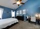 Bright main bedroom featuring a ceiling fan, desk, and ample closet space at 12729 Mcginnis Ln, Huntersville, NC 28078
