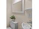 Cozy bathroom features a toilet with a small plant on top, a sink, and a large mirror at 133 2Nd Ave, China Grove, NC 28023