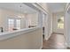 Hallway with wooden floors leads to a dining area with large french doors and natural light at 133 2Nd Ave, China Grove, NC 28023