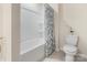 Full bathroom featuring a tub and shower combination with white tiled walls and decorative curtain at 141 Rhuidean Ct, Troutman, NC 28166