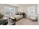 Comfortable bedroom with two windows allowing natural light and a decorative bench at the end of the bed at 141 Rhuidean Ct, Troutman, NC 28166