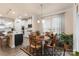 Bright dining area with wooden table and chairs adjoining a modern kitchen space at 141 Rhuidean Ct, Troutman, NC 28166