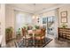 Cozy dining area with backyard access, a round wooden table, and natural lighting at 141 Rhuidean Ct, Troutman, NC 28166